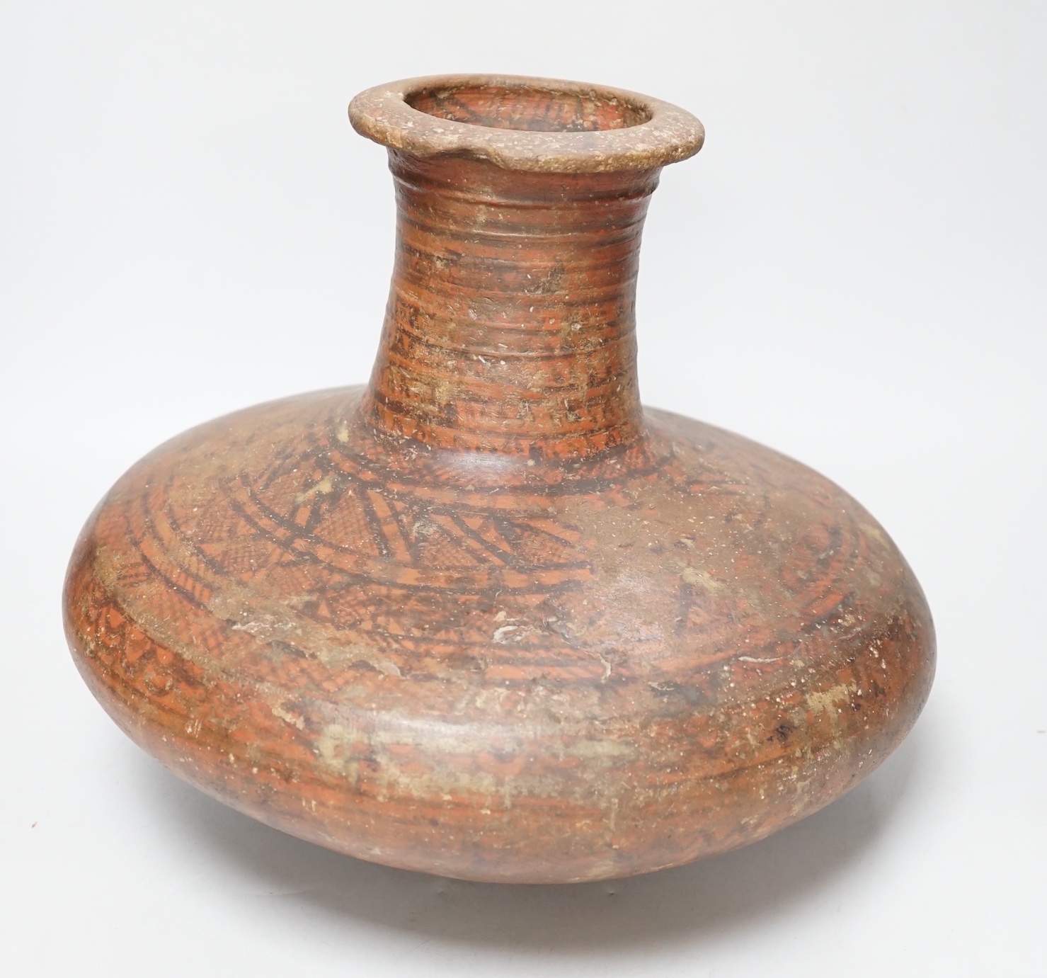 An Indian Rajasthan clay vase hand painted with a geometric design, 30cm high